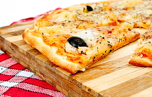 cheese pizza on brown wooden board